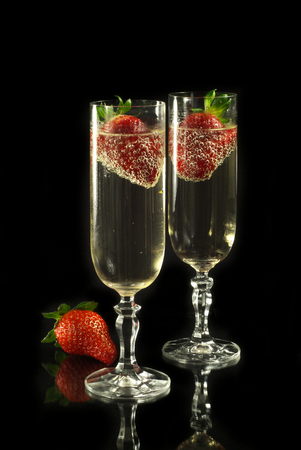 Golden champagne with strawberriesの写真素材