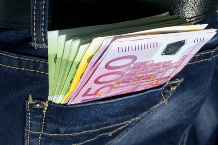 Money in blue jeans pocketの写真素材