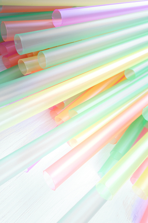 Bright colorful drinking straws on white background