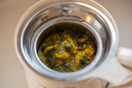 DIY concept. Ceramic handmade decorative cup with hot herbal tea...の写真素材