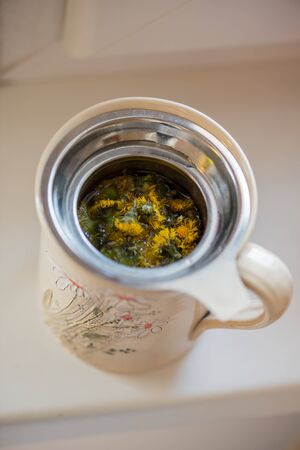 DIY concept. Ceramic handmade decorative cup with hot herbal tea...の写真素材