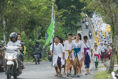 Balinese villagers participating in traditional religious Hindu procession before Ogoh-ogoh parade and Nyepi day (Balinese New Year) in Canggu, Bali on March 30, 2014のeditorial素材