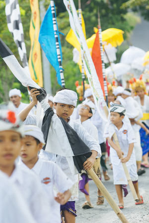 BALI, INDONESIA - MARCH 30: Balinese villagers participating in traditional religious Hindu procession before Ogoh-ogoh parade and Nyepi day (Balinese New Year) in Canggu, Bali on March 30, 2014のeditorial素材