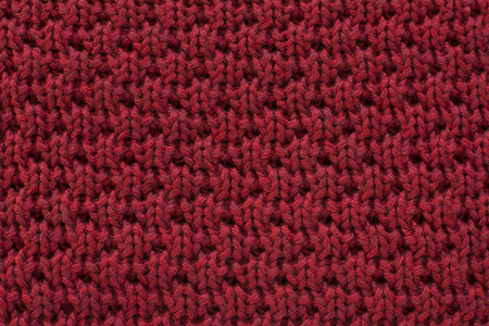 Bright red knitted wool fabric texture backgroundの写真素材