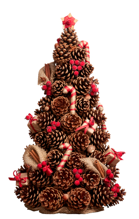 Christmas tree made of cones decorated with cinnamon sticks, nutmeg. Hand-made. Element for Christmas and New Year design. Isolated on white.の写真素材