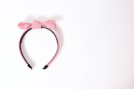 Pink hair band with ribbon isolated on white background, fashion hairstyle for girl. Hairdresser accessory and decoration for clothing and costume.の写真素材