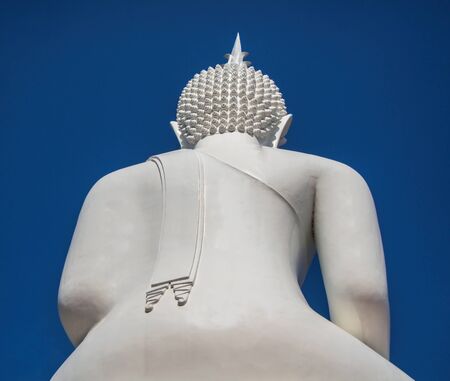 back side the big white buddha on blue sky background in thailandの写真素材