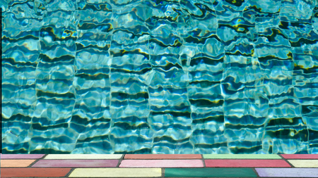 top of colorful brick in front of water ripple pattern in pool on sunny day