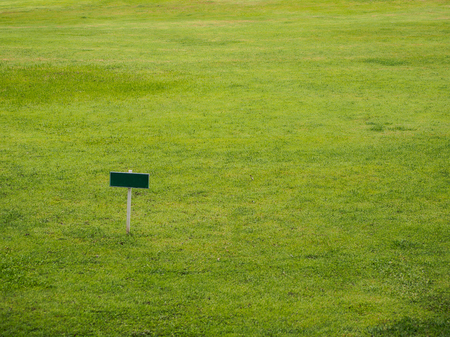 blank sign board in the lawnの写真素材