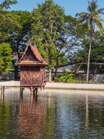 The scripture hall is made of wood located in the pond,thai styleの写真素材