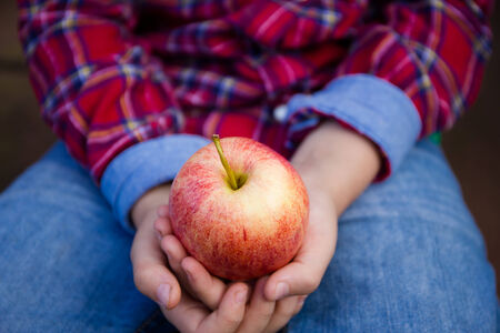 Boy holding an appleの写真素材