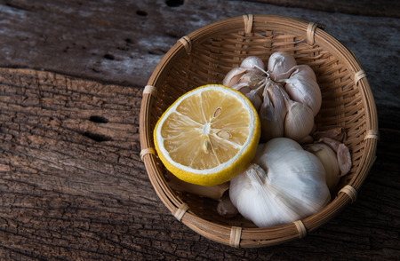 Dried lemon in the basket with garlic for herb ingredient in the kitchen.の写真素材