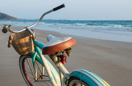 Seascape and the bicycle on the beach photo with ourdoor sunset low lighting.の写真素材