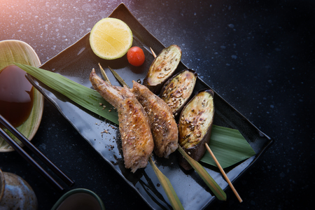Grill chicken wing with salt seasoning in Japanese skewer grill food style.の写真素材