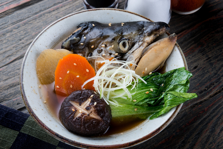 Salmon head in soya soup steamed with ingredient in Japanese style food.の写真素材