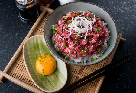 Ground raw tuna and onion with rice in Japanese style call nekitoro don set in bowl ready to serve.