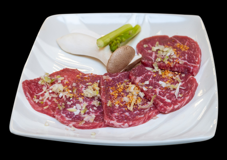 Japanese beef yakiniku menu in white plate dicut from black background.の写真素材
