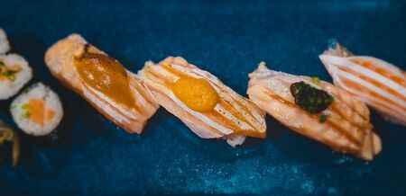Salmon belly sushi set with lowlighting darkshadow and low aperture depth of field style.の写真素材