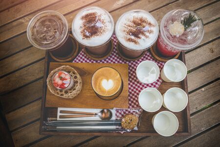 Coffee shop drink mix set about cold and hot coffee cocoa and cup cake in wooden plate serve.の写真素材