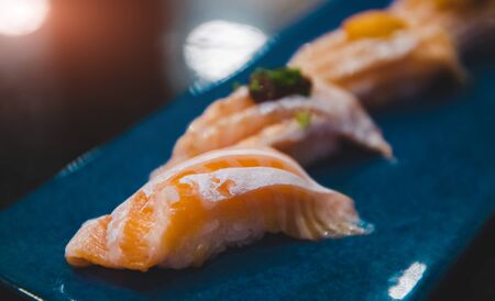Salmon belly sushi set with lowlighting darkshadow and low aperture depth of field style.の写真素材