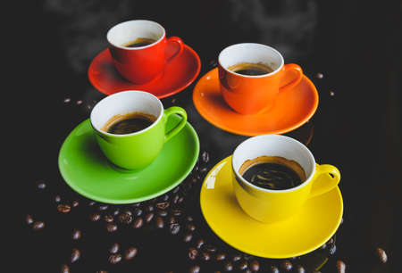 Colorful of espresso coffee cups setting with dark background and coffee bean.の写真素材