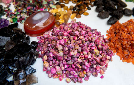 Mix shape and colorful mineral gemstones in jewelry market with outdoor lighting.の写真素材