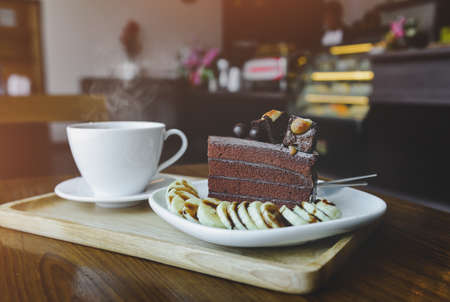 Brownies chocolate cake and  hot tea with indoor morning lighting.の写真素材