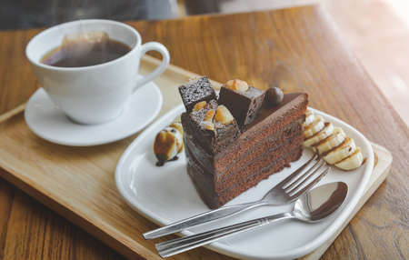 Brownies chocolate cake and  hot tea with indoor morning lighting.の写真素材