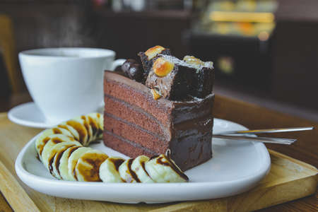 Brownies chocolate cake and  hot tea with indoor morning lighting.の写真素材