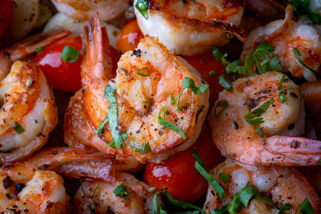 Grilled spicey shrimps with seasoning and vegetables.の写真素材