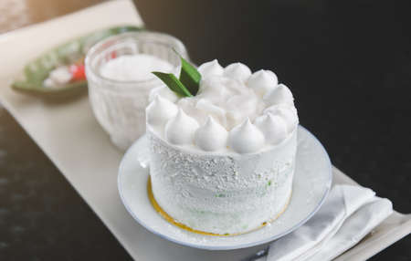 White coconut cake set with indoor lighting.の写真素材