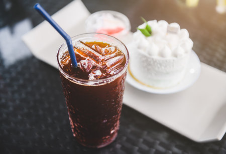 White coconut cake set and coffee  with indoor lighting.の写真素材