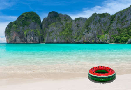Swimming ring bouy on the beach and blue sea island with outdoor sun lighting.の写真素材