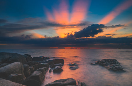 The stones in the sea with cloud sky in sunset time lighting and dark shadow..の写真素材