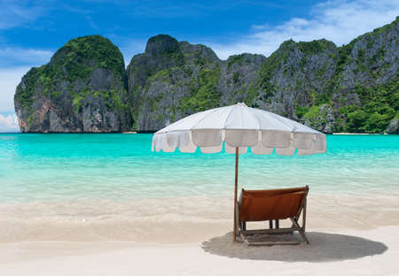 Blue sea island beach and relax chair with umbrella.の写真素材