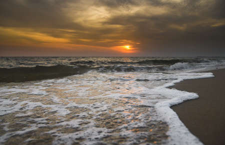 Lanscape of sunset sky beach and sea wave  with outdoor low lighting and dark shadow.の写真素材