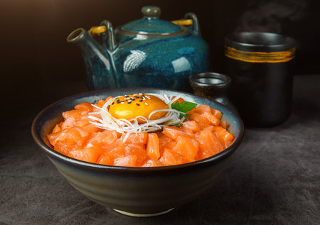 bowl of salmon and rice with a yolk on top,The yolk is sunny side up and runny.の写真素材