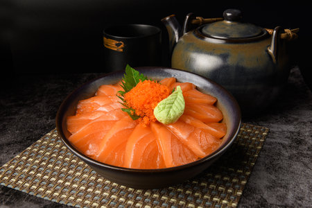 Salmon sashimi don, Salmond slice with rice bowl in Japanese style food with dark background.の写真素材