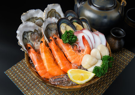 Seafood on a large plate. Assorted seafood from oysters, shrimp hotate and takoの写真素材