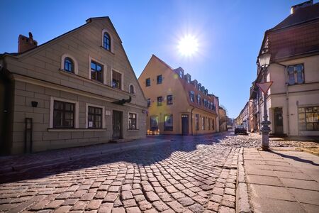 Cobbled pavements of old town streets in Klaipeda, Lithuania on sunny day. Old buildings, houses,...