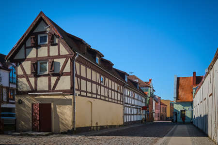 Typical fachwerk houses of old Klaipeda, Lithuania medieval town and cobbled pavement street. German...