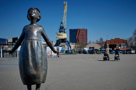 April 17, 2019, Klaipeda, Lithuania - City attraction. Statue of unknown little girl in port of Klaipeda, Lithuania on sunny dayのeditorial素材