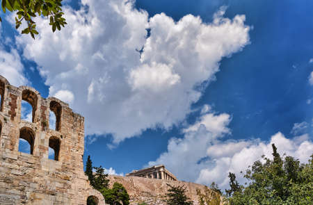 View of Odeon of Herodes Atticus theater on Acropolis hill, Athens, Greece, at bright blue sky and super clouds. Classic ancient Greek theater ruinsの写真素材
