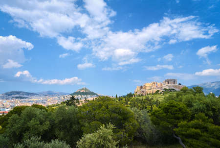 Iconic view of Acropolis hill and Lycabettus hill in background in Athens, Greece from Pnyx hill in...