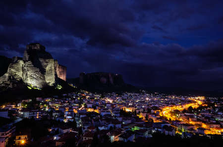 Night view of Kalambaka and Kastraki village at foot of high cliffs and rocks of Meteora valley. Greece,の写真素材