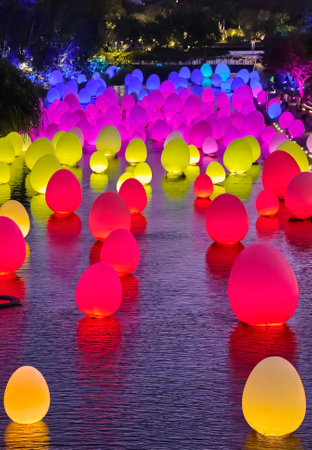 Singapore - Feb 25, 2020. Neon eggs float on water in Dragonfly lake, Gardens by the bay. Temporary...