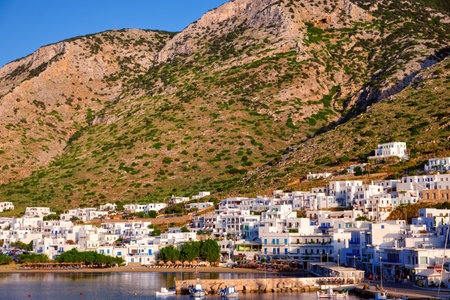 Beautiful view of Mediterranean island at sunset. Whitewashed houses, hills, clear sky, blue sea waters, beaches. Small Greek village of Milos, Greeceの写真素材