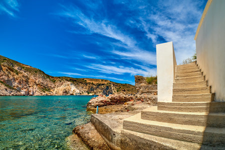 Stairs to azure sea waters of remote bay on Greek island on summer day.の写真素材