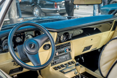 Lisbon, Portugal - Jan 20, 2024: Car design details, interior of vintage Aston Martin V8 in full leather, authentic steering wheel with Aston Martin logo and front panelのeditorial素材