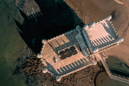 Top down or drone flat lay view of Belem tower, Lisbon, Portugal on sunny day. Medieval fort on Tagus river in late Gothic or Manueline style, UNESCO world heritage site, Age of Discoveries, tourist attraction, Portuguese seafaring historyの写真素材